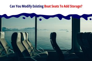 A scenic view of comfortable boat seats facing large windows with a tranquil ocean and distant mountains in the background. The image is captioned with the text "Can You Modify Existing Boat Seats To Add Storage?" in bold colours, emphasizing the possibility of enhancing boat seats with additional storage solutions.