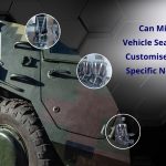 Custom military vehicle seats with ergonomic designs, featuring armrests and safety harnesses inside a camouflaged military vehicle.